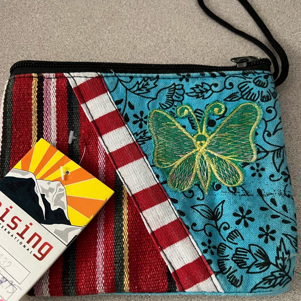 Boho wallet NWT with one zipper, and a strap. Cute pattern on the front